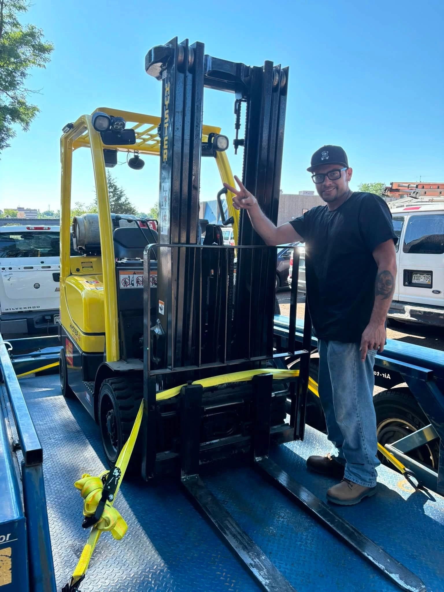 Forklift training graduate beside equipment